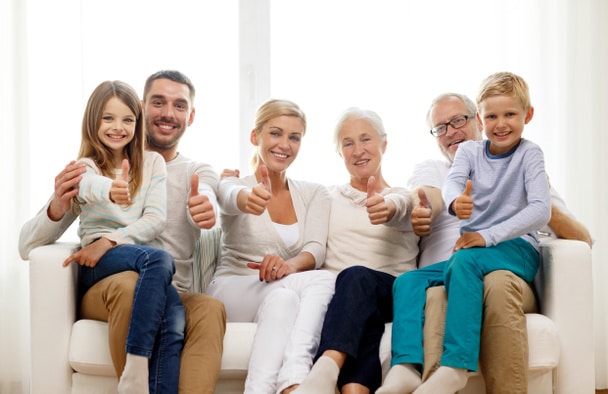 Happy family sitting on a couch at home using DigiVibe